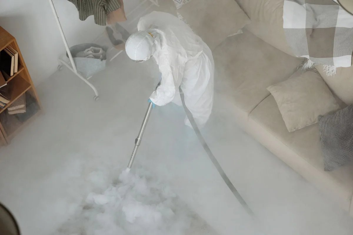 Biohazard cleanup technician in protective equipment, Wolverine Lake, MI